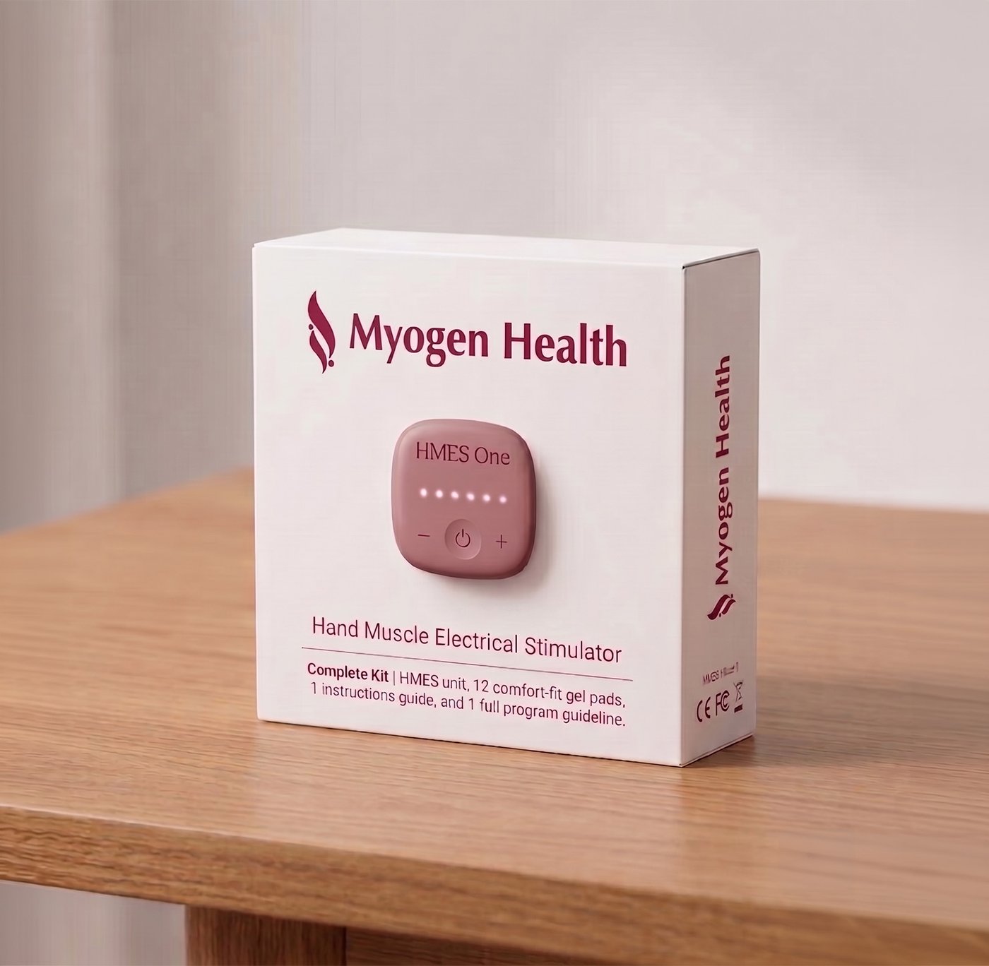 The Myogen Health HMES One Complete Kit packaging box on a wooden table.